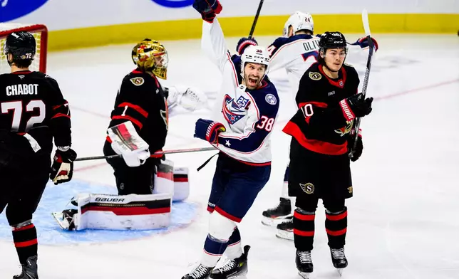 Columbus Blue Jackets' Boone Jenner (38) celebrates after a goal by teammate Denton Mateychuk (not shown) against Ottawa Senators goaltender Leevi Meriläinen (1) during third-period NHL hockey game action in Ottawa, Ontario, Monday, Dec. 29, 2025. (Spencer Colby/The Canadian Press via AP)