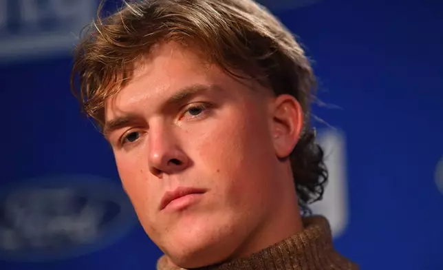 New York Giants quarterback Jaxson Dart reacts during a news conference while talking to the media after a loss to the New England Patriots in an NFL football game Monday, Dec. 1, 2025, in Foxborough, Mass. (AP Photo/Steven Senne)