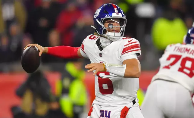 New York Giants quarterback Jaxson Dart passes against the New England Patriots during the first half of an NFL football game, Monday, Dec. 1, 2025, in Foxborough, Mass. (AP Photo/Steven Senne)