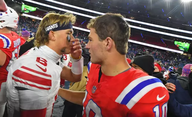New York Giants quarterback Jaxson Dart (6) and New England Patriots quarterback Drake Maye (10) talk following an NFL football game Monday, Dec. 1, 2025, in Foxborough, Mass. (AP Photo/Steven Senne)