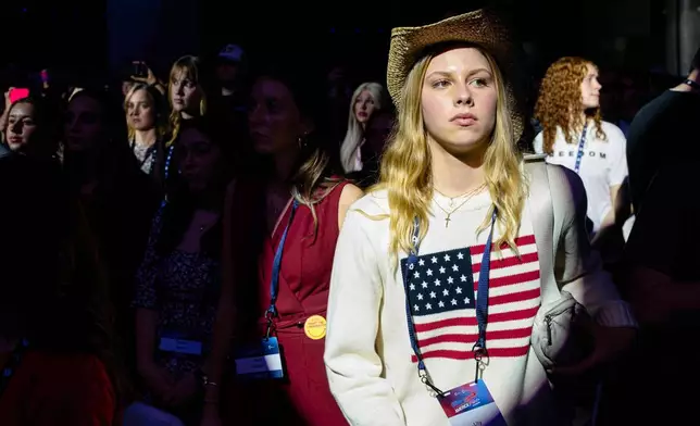 Attendees stand during Turning Point USA's AmericaFest 2025, Thursday, Dec. 18, 2025, in Phoenix. (AP Photo/Jon Cherry)