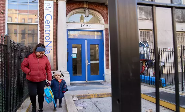 Families leave CentroNia at the end of the school day in Washington, Tuesday, Dec. 9, 2025. (AP Photo/Jacquelyn Martin)
