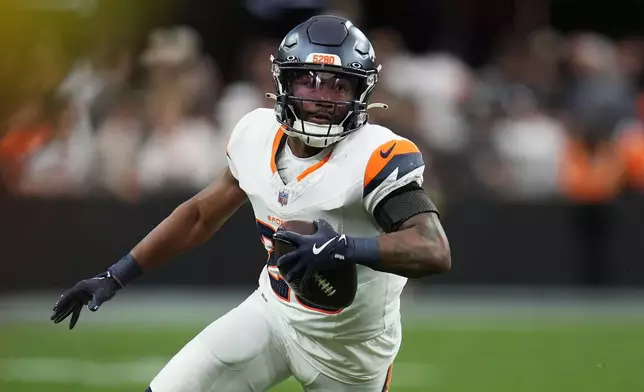 Denver Broncos running back Tyler Badie runs against the Las Vegas Raiders during the first half of an NFL football game in Las Vegas, Sunday, Dec. 7, 2025. (AP Photo/Gregory Bull)