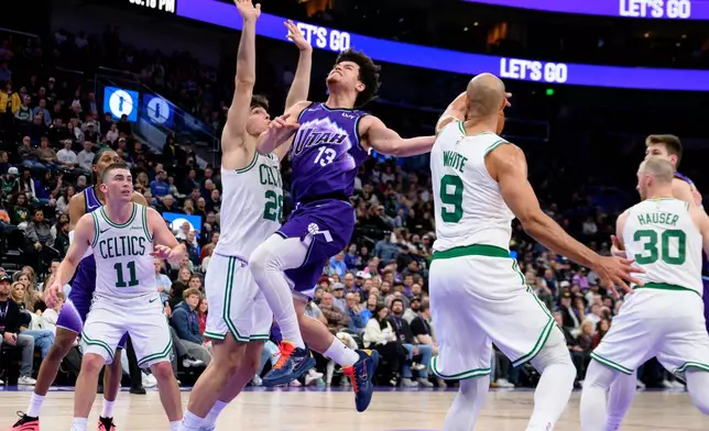 Boston Celtics guard Derrick White (9) steals the ball away from Utah Jazz guard Walter Clayton Jr. (13) as he was driving to the basket during the second half of an NBA basketball game, Tuesday, Dec. 30, 2025, in Salt Lake City. (AP Photo/Tyler Tate)