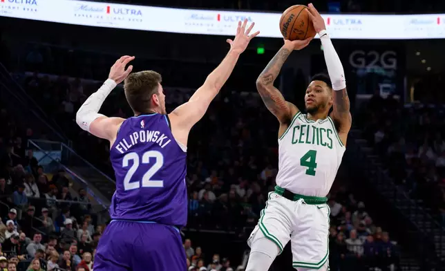 Boston Celtics guard Anfernee Simons (4) shoots over Utah Jazz forward Kyle Filipowski (22) during the first half of an NBA basketball game, Tuesday, Dec. 30, 2025, in Salt Lake City. (AP Photo/Tyler Tate)