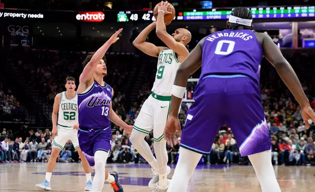 Boston Celtics guard Derrick White, center right, looks to shoot guarded by Utah Jazz guard Walter Clayton Jr., center left, during the first half of an NBA basketball game, Tuesday, Dec. 30, 2025, in Salt Lake City. (AP Photo/Tyler Tate)