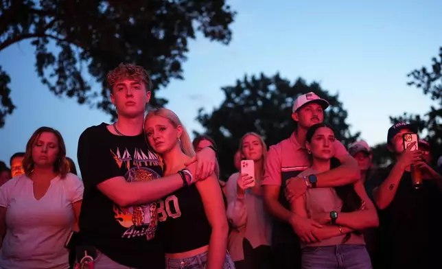 FILE - Utah Valley University students Zach Zimmerman, second from left, and Lauren Simons embrace during a vigil for Charlie Kirk, the CEO and co-founder of Turning Point USA who was shot and killed, Thursday, Sept. 11, 2025, in Orem, Utah. Zimmerman witnessed the shooting. (AP Photo/Lindsey Wasson, File)