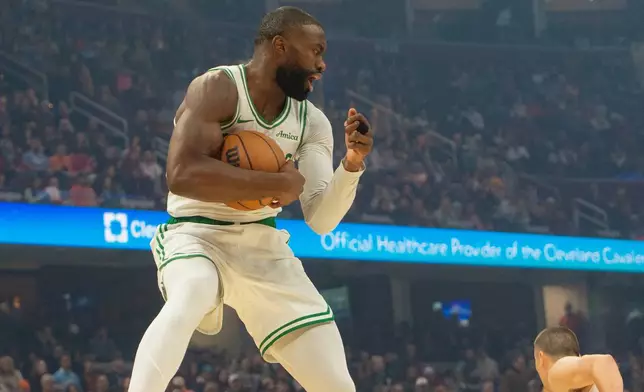 Boston Celtics' Jaylen Brown grabs a rebound against the Cleveland Cavaliers during the first half of an NBA basketball game in Cleveland, Sunday, Nov. 30, 2025. (AP Photo/Phil Long)