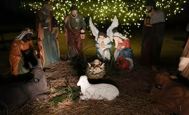 FILE - A Nativity scene is illuminated by a Christmas tree on Payrow Plaza in Bethlehem, Pa., known as "Christmas City, USA," on Sunday, Dec. 1, 2024. (AP Photo/Luis Andres Henao, File)