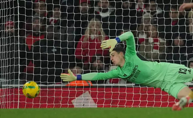 Arsenal's goalkeeper Kepa Arrizabalaga saves during the English Football League Cup quarter-final soccer match between Arsenal and Crystal Palace in London, Tuesday, Dec. 23, 2025. (AP Photo/Kin Cheung)