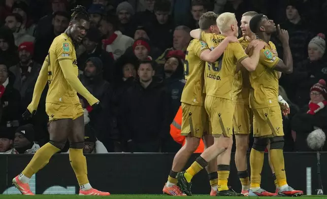 Crystal Palace players celebrate after a goal during the English Football League Cup quarter-final soccer match between Arsenal and Crystal Palace in London, Tuesday, Dec. 23, 2025. (AP Photo/Kin Cheung)