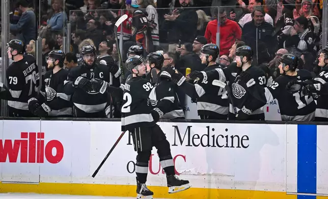 Los Angeles Kings defenseman Brandt Clarke (92) celebrates with teammates after scoring during the first period of an NHL hockey game against the Anaheim Ducks, Saturday, Dec. 27, 2025, in Los Angeles. (AP Photo/Katie Chin)