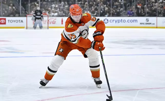 Anaheim Ducks defenseman Jacob Trouba (65) skates with the puck during the second period of an NHL hockey game against the Los Angeles Kings, Saturday, Dec. 27, 2025, in Los Angeles. (AP Photo/Katie Chin)
