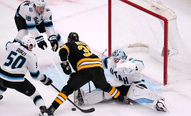 Utah Mammoth goaltender Vitek Vanecek (41) makes a save on a shot by Boston Bruins center Morgan Geekie (39) during the third period of an NHL hockey game, Tuesday, Dec. 16, 2025, in Boston. (AP Photo/Charles Krupa)