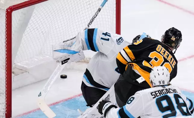 Boston Bruins center Morgan Geekie (39) shoots the puck past Utah Mammoth goaltender Vitek Vanecek (41), for his second goal of the night, during the second period of an NHL hockey game, Tuesday, Dec. 16, 2025, in Boston. (AP Photo/Charles Krupa)