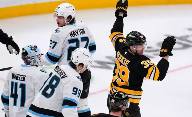 Boston Bruins center Morgan Geekie (39) celebrates after his goal against Utah Mammoth goaltender Vitek Vanecek (41), his second goal of the night, during the second period of an NHL hockey game, Tuesday, Dec. 16, 2025, in Boston. (AP Photo/Charles Krupa)