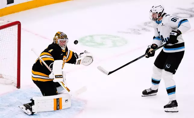Boston Bruins goaltender Jeremy Swayman (1) makes the save on a shot by Utah Mammoth center Kevin Stenlund (82) during the first period of an NHL hockey game, Tuesday, Dec. 16, 2025, in Boston. (AP Photo/Charles Krupa)