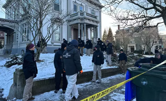 FBI officials search an area of Providence, R.I., Monday, Dec. 15, 2025. (AP Photo/Leah Willingham)