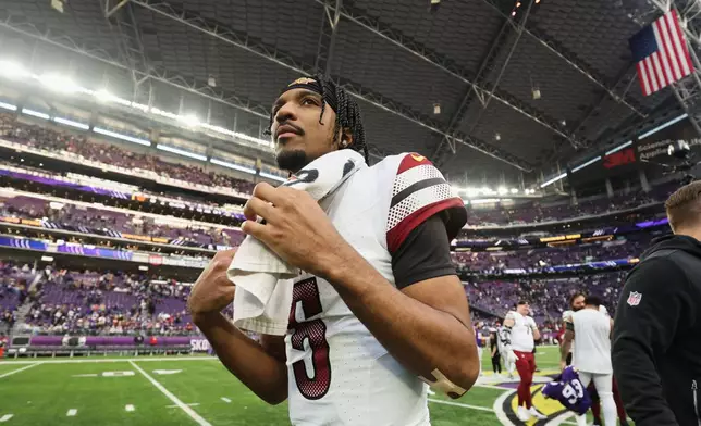Washington Commanders quarterback Jayden Daniels (5) walks off the field after an NFL football game against the Minnesota Vikings, Sunday, Dec. 7, 2025, in Minneapolis. (AP Photo/Matt Krohn)