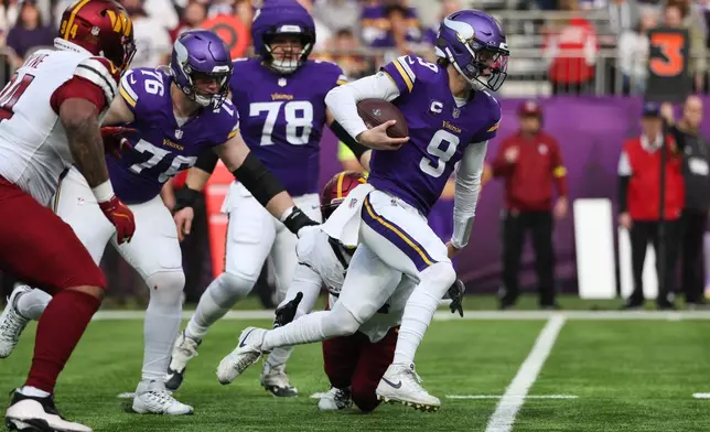 Minnesota Vikings quarterback J.J. McCarthy (9) runs with the ball during the first half of an NFL football game against the Washington Commanders, Sunday, Dec. 7, 2025, in Minneapolis. (AP Photo/Matt Krohn)