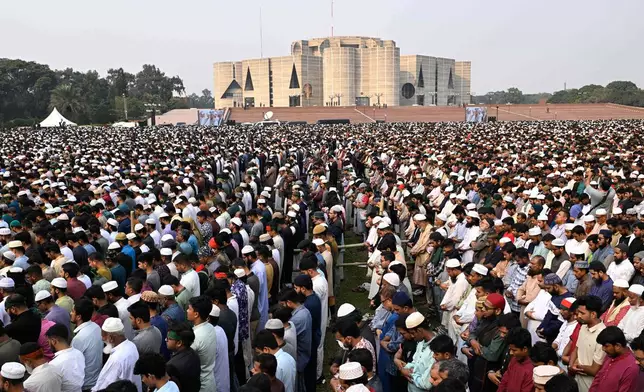 People offer funeral prayers for leading Bangladeshi activist Sharif Osman Hadi, who died from gunshot wounds sustained in an attack in Dhaka earlier this month, outside the nation's Parliament complex in Dhaka, Bangladesh, Saturday, Dec. 20, 2025. (AP Photo/Mahmud Hossain Opu)