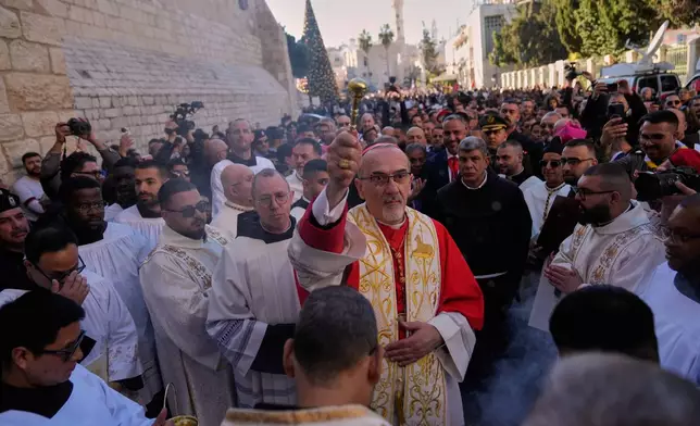 Latin Patriarch Pierbattista Pizzaballa, the top Catholic clergyman in the Holy Land, arrives at the Church of the Nativity, traditionally believed to be the birthplace of Jesus, on Christmas Eve, in the West Bank city of Bethlehem, Wednesday, Dec. 24, 2025. (AP Photo/Nasser Nasser)