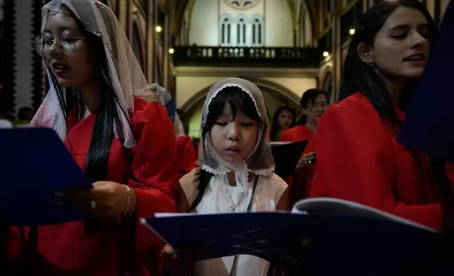 Christians attend prayer on Christmas Eve, Wednesday, Dec. 24, 2025, at St. Mary Cathedral in Yangon, Myanmar. (AP Photo/Thein Zaw)