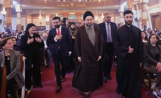 Ammar al-Hakim, center, a Shiite leader attends a Christmas Eve Mass at Our Lady of Salvation Church in central Baghdad, Iraq, Wednesday, Dec. 24, 2025. (AP Photo/Hadi Mizban)