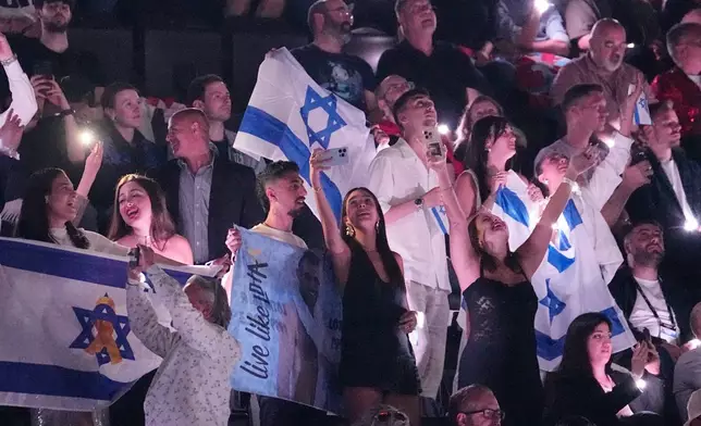 FILE - Israeli fans cheer for Yuval Raphael, from Israel, after she performed during the semi-final of the 69th Eurovision Song Contest in Basel, Switzerland, May 15, 2025. (AP Photo/Martin Meissner, File)