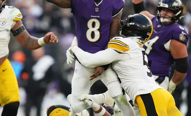 Pittsburgh Steelers linebacker Alex Highsmith (56) and linebacker Nick Herbig (51) tackle Baltimore Ravens quarterback Lamar Jackson (8) during the second half of an NFL football game, Sunday, Dec. 7, 2025, in Baltimore. (AP Photo/Stephanie Scarbrough)