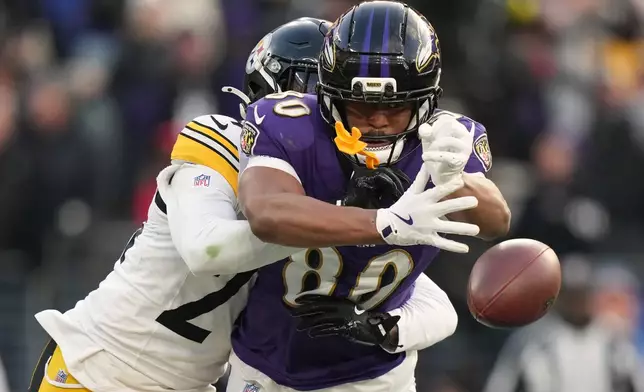 Pittsburgh Steelers cornerback Joey Porter Jr. (24) breaks up a pass intended for Baltimore Ravens tight end Isaiah Likely (80) during the second half of an NFL football game, Sunday, Dec. 7, 2025, in Baltimore. (AP Photo/Stephanie Scarbrough)