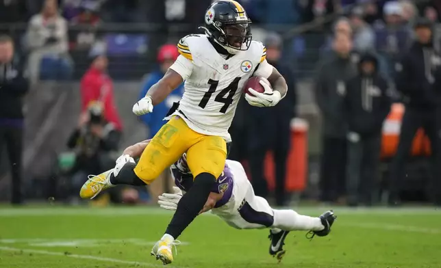 Pittsburgh Steelers running back Kenneth Gainwell (14) runs the ball against Baltimore Ravens safety Keondre Jackson (39) during the second half of an NFL football game, Sunday, Dec. 7, 2025, in Baltimore. (AP Photo/Stephanie Scarbrough)