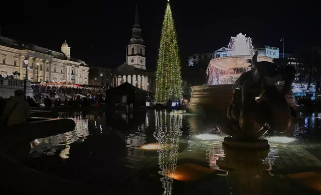The traditional lighting up ceremony starts for the annual Norwegian gifted Christmas tree in Trafalgar Square, in London, England, Thursday, Dec. 4, 2025. (AP Photo/Thomas Krych)