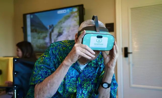 Bob Rogallo watches video through a Rendever virtual-reality headset at the Forum at Rancho San Antonio retirement community in Cupertino, Calif. on June 11, 2025. (AP Photo/Terry Chea)