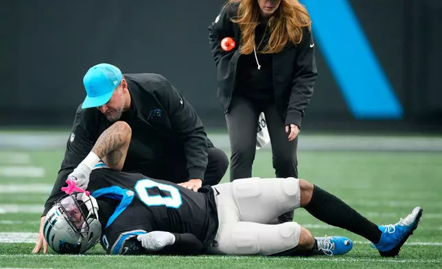 Carolina Panthers tight end Ja'Tavion Sanders is treated on the field during the first half of an NFL football game against the Seattle Seahawks, Sunday, Dec. 28, 2025, in Charlotte, N.C. (AP Photo/Jacob Kupferman)