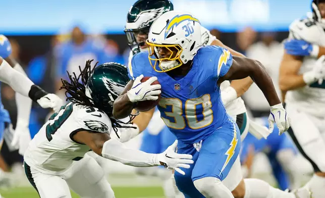 Los Angeles Chargers running back Kimani Vidal (30) carries during the second half of an NFL football game against the Philadelphia Eagles, Monday, Dec. 8, 2025, in Inglewood, Calif. (AP Photo/Caroline Brehman)