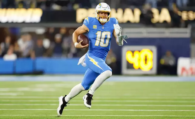 Los Angeles Chargers quarterback Justin Herbert (10) runs during the second half of an NFL football game against the Philadelphia Eagles, Monday, Dec. 8, 2025, in Inglewood, Calif. (AP Photo/Caroline Brehman)