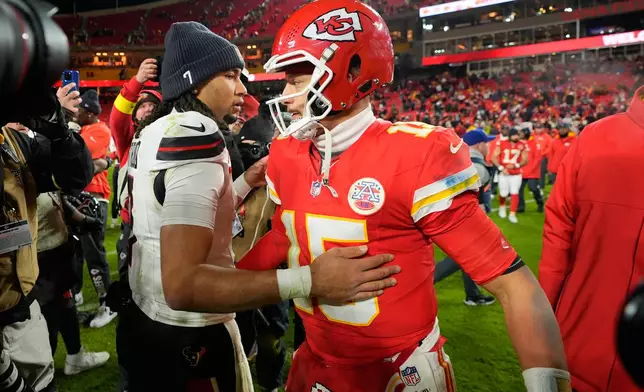 Kansas City Chiefs quarterback Patrick Mahomes (15) and Houston Texans quarterback C.J. Stroud, left, hug following an NFL football game Sunday, Dec. 7, 2025, in Kansas City, Mo. (AP Photo/Charlie Riedel)