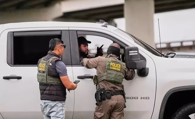 FILE - Customs and Border Patrol agents question occupants of a vehicle they pulled over, during an immigration crackdown in Kenner, La., Dec. 5, 2025. (AP Photo/Gerald Herbert, File)