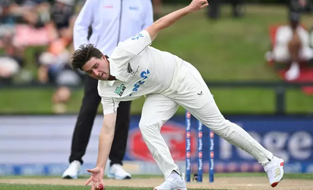 New Zealand's Zak Foulkes fields off his own bowling against the West Indies on Day 4 of their cricket test match in Christchurch, New Zealand, Friday, Dec. 5, 2025. (Andrew Cornaga/Photosport via AP)
