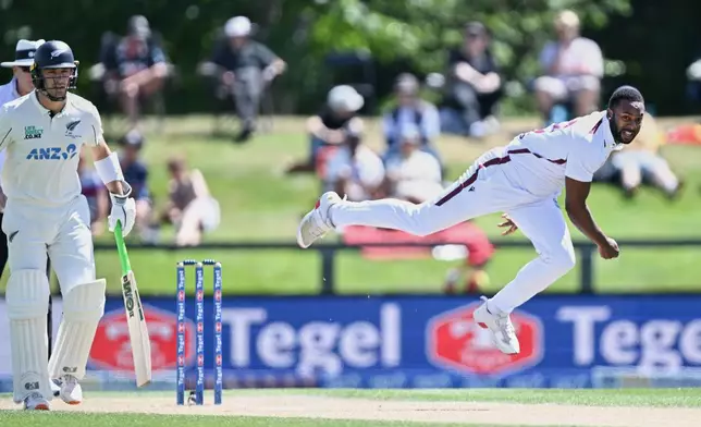 West Indies' Jayden Seales, right, bowls to New Zealand on day 4 of their cricket test match in Christchurch, New Zealand, Friday, Dec. 5, 2025. (Andrew Cornaga/Photosport via AP)