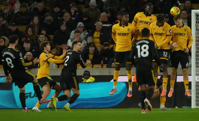 Manchester United's Bruno Fernandes executes a free kick during the Premier League soccer match between Wolverhampton Wandere and Manchester United in Wolverhampton, England Monday, Dec. 8, 2025. (AP Photo/Dave Shopland)