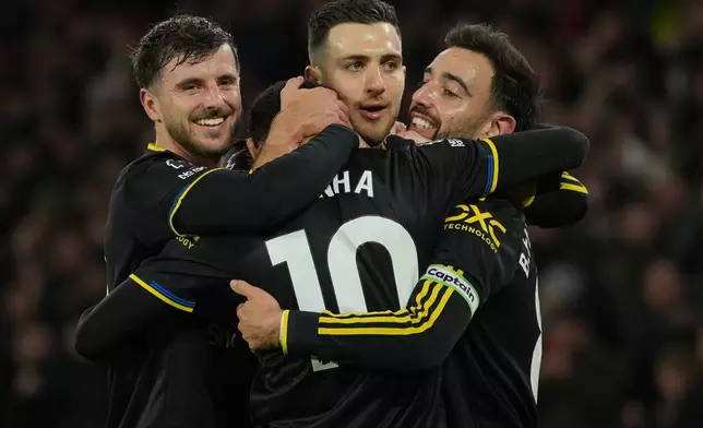 Manchetser United players celebrate after a goal during the Premier League soccer match between Wolverhampton Wandere and Manchester United in Wolverhampton, England Monday, Dec. 8, 2025. (AP Photo/Dave Shopland)