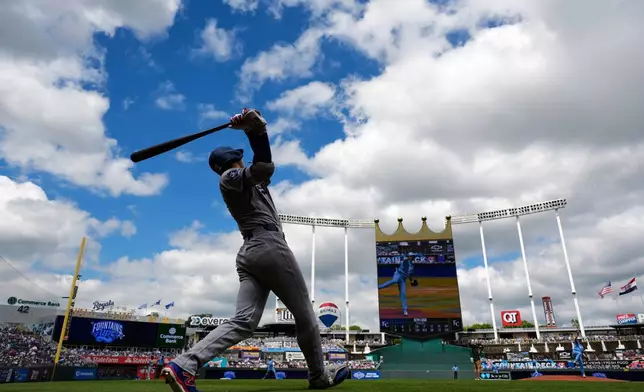 FILE - Los Angeles Dodgers' Shohei Ohtani warms up on deck before a baseball game against the Kansas City Royals, Saturday, June 28, 2025, in Kansas City, Mo. (AP Photo/Charlie Riedel, File)