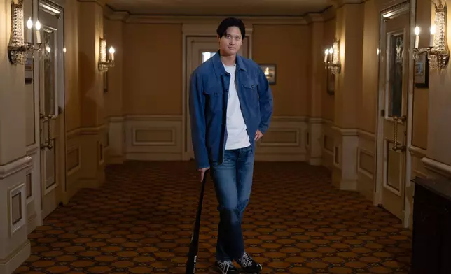 Los Angeles Dodgers' Shohei Ohtani poses for photos after an interview with The Associated Press in Pasadena, Calif., Wednesday, Nov. 26, 2025. (AP Photo/Jae C. Hong)