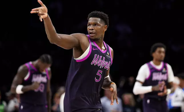 Minnesota Timberwolves guard Anthony Edwards celebrates his three-point basket against the Oklahoma City Thunder during the second half of an NBA basketball game Friday, Dec. 19, 2025, in Minneapolis. (AP Photo/Matt Krohn)