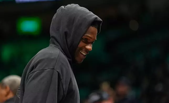 Minnesota Timberwolves guard Anthony Edwards (5) smiles during a timeout in the first half of an NBA basketball game against the Memphis Grizzlies, Wednesday, Dec. 17, 2025, in Minneapolis. (AP Photo/Abbie Parr)