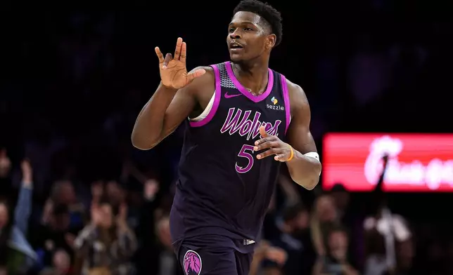 Minnesota Timberwolves guard Anthony Edwards celebrates his three-point basket against the Oklahoma City Thunder during the second half of an NBA basketball game Friday, Dec. 19, 2025, in Minneapolis. (AP Photo/Matt Krohn)
