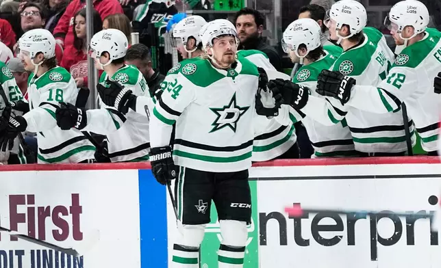 Dallas Stars center Roope Hintz celebrates with the bench after scoring during the second period of an NHL hockey game against the Detroit Red Wings Tuesday, Dec. 23, 2025, in Detroit. (AP Photo/Ryan Sun)