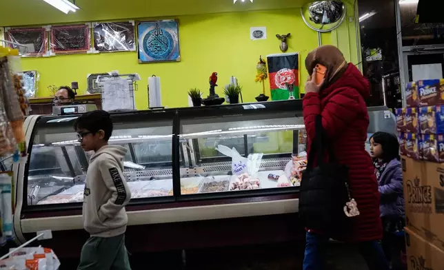 A family walks into Sana Market and Bakery, an Afghan grocery store in Carmichael, Calif., Friday, Dec. 5, 2025. (AP Photo/Godofredo A. Vásquez)